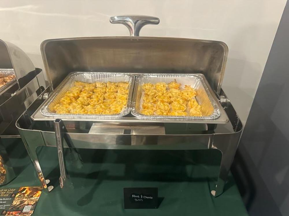 Chafing dishes of barbecue and sides set up for a corporate lunch