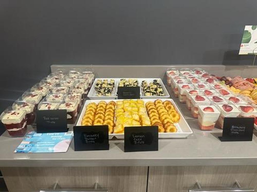 A dessert table laid out with cakes and individual desserts