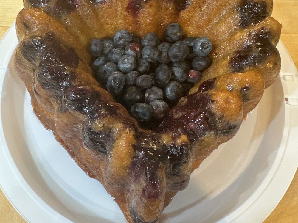 A blueberry bundt cake on a white plate