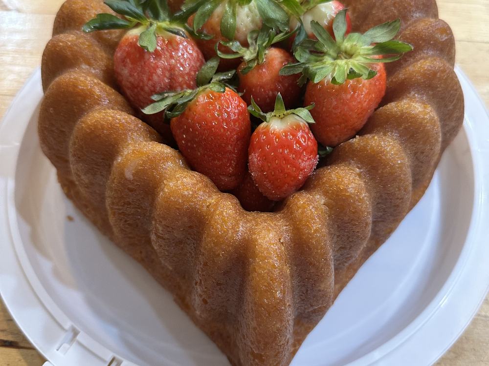 A bundt cake ringed with fresh strawberries