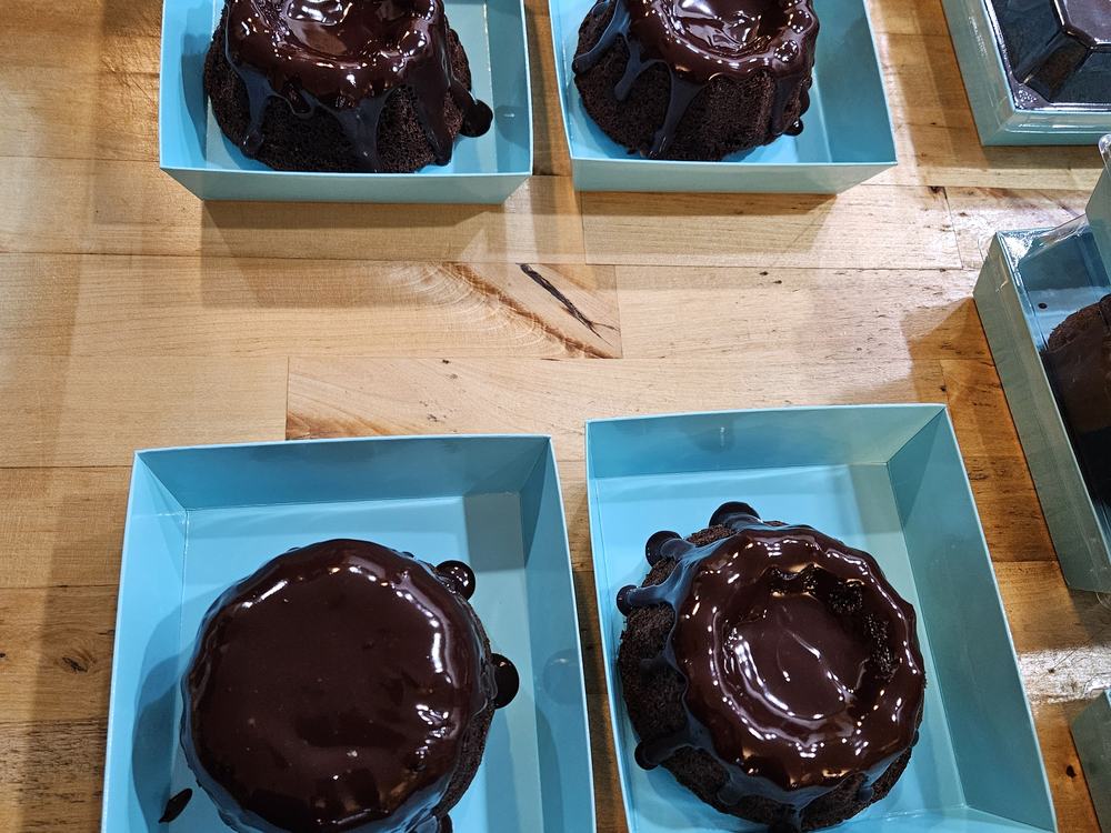Individual chocolate ganache desserts plated for a corporate event