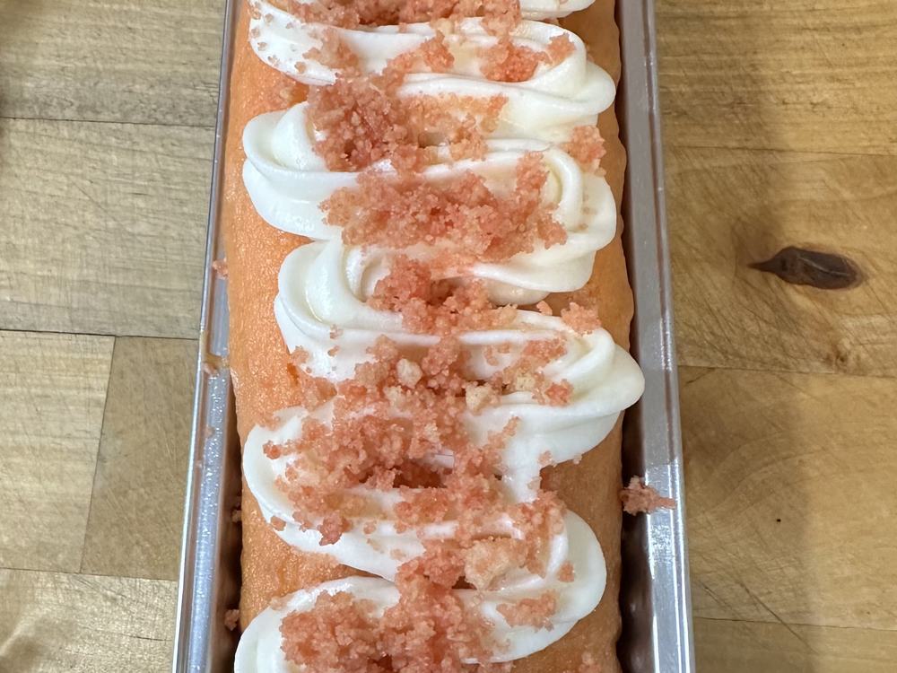 A strawberry crunch pound cake piped with cream