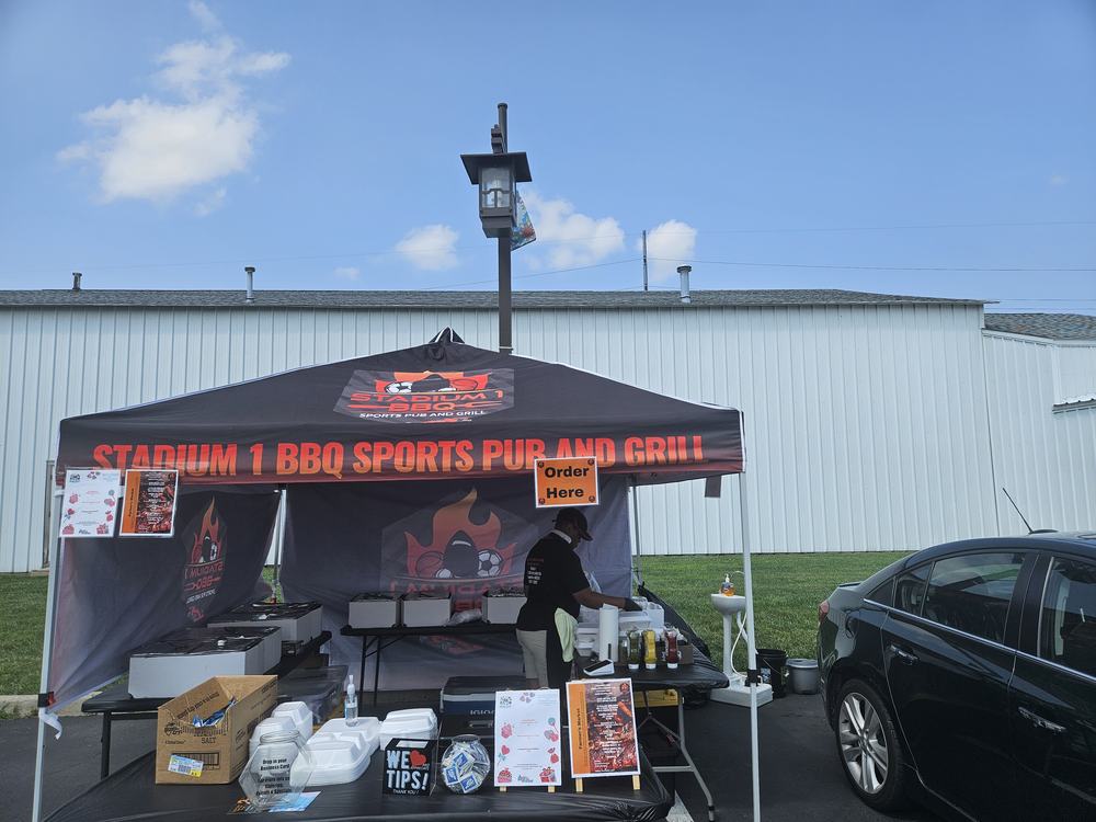 The Stadium 1 BBQ tent set up at a farmers market