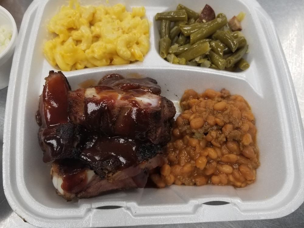 A barbecue plate with ribs, mac and cheese and sides