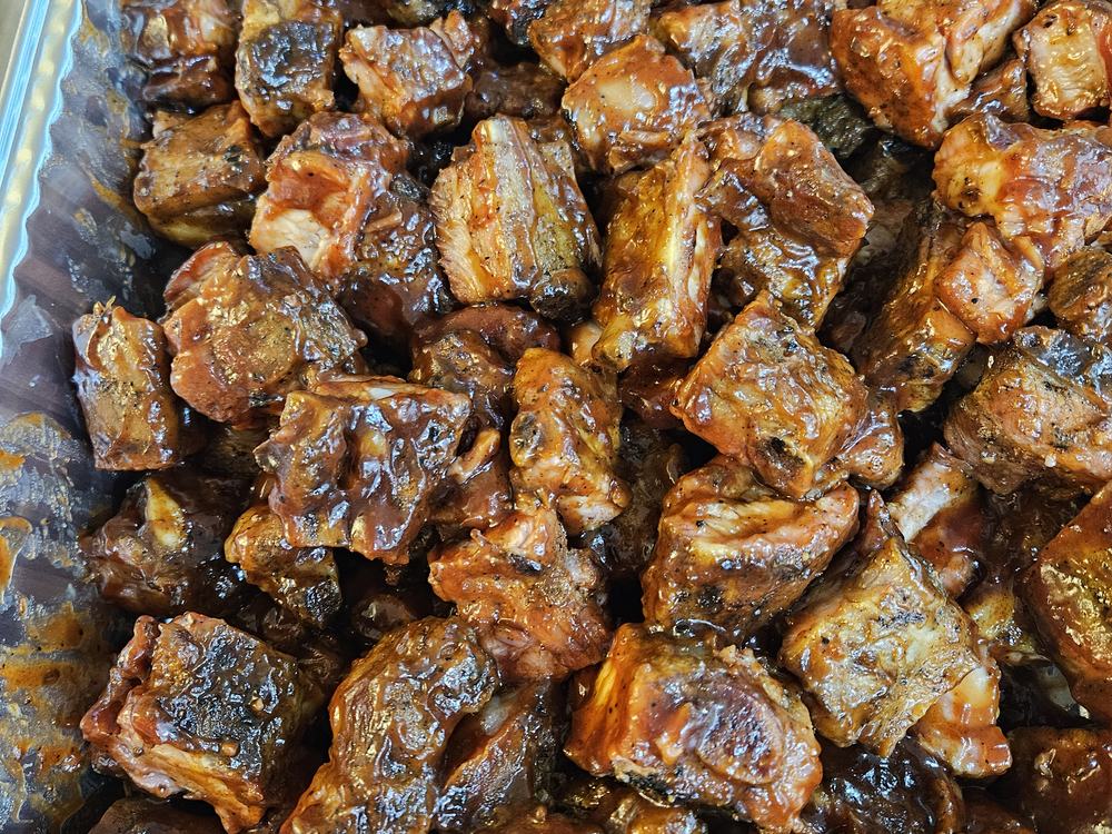 A catering pan filled with sauced rib tips