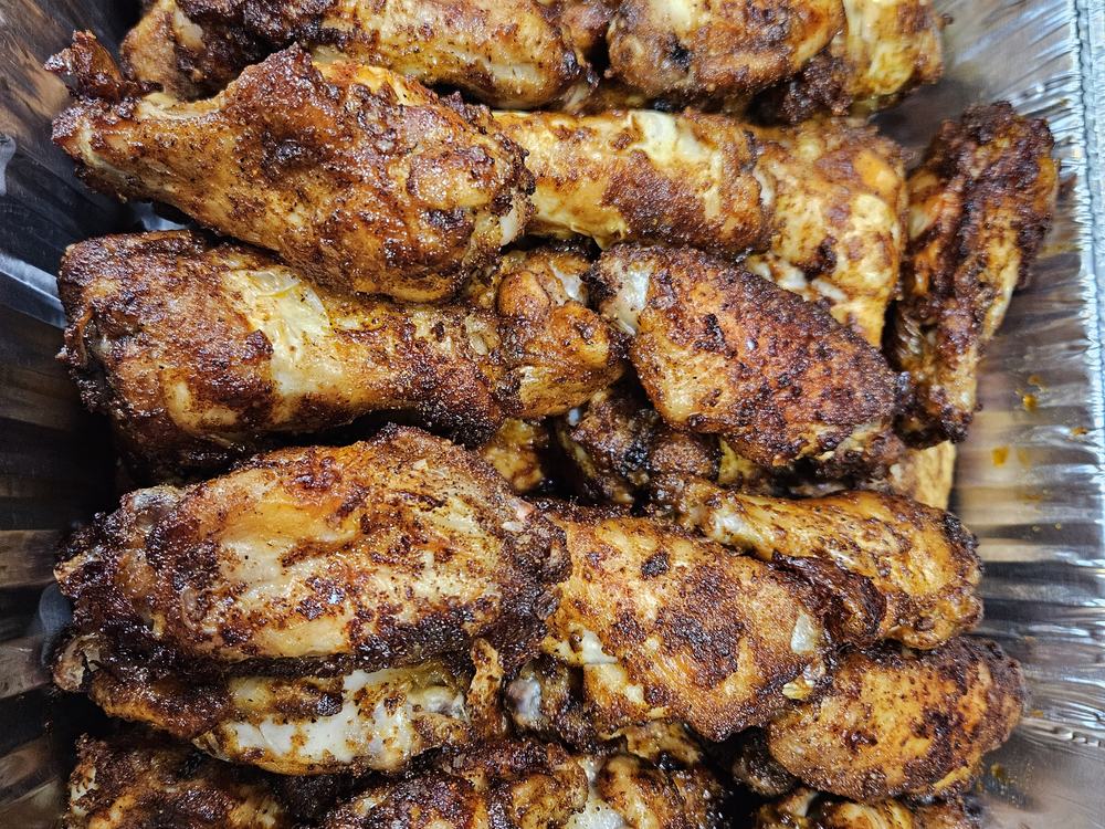 A pan of grilled wings ready for the market