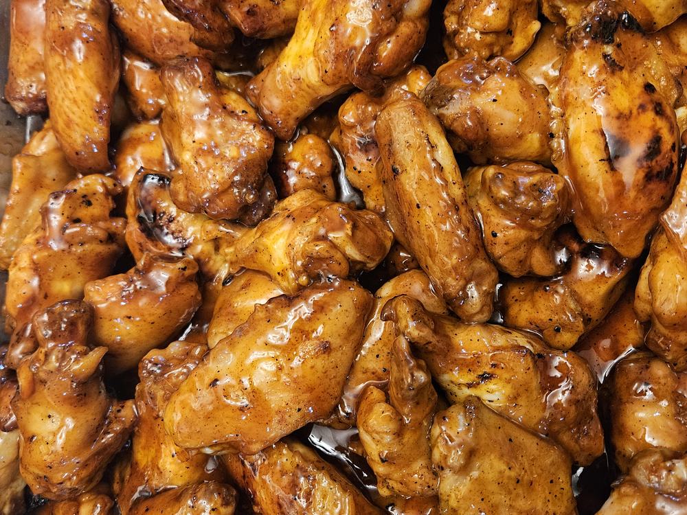 Barbecue wings piled in a serving pan
